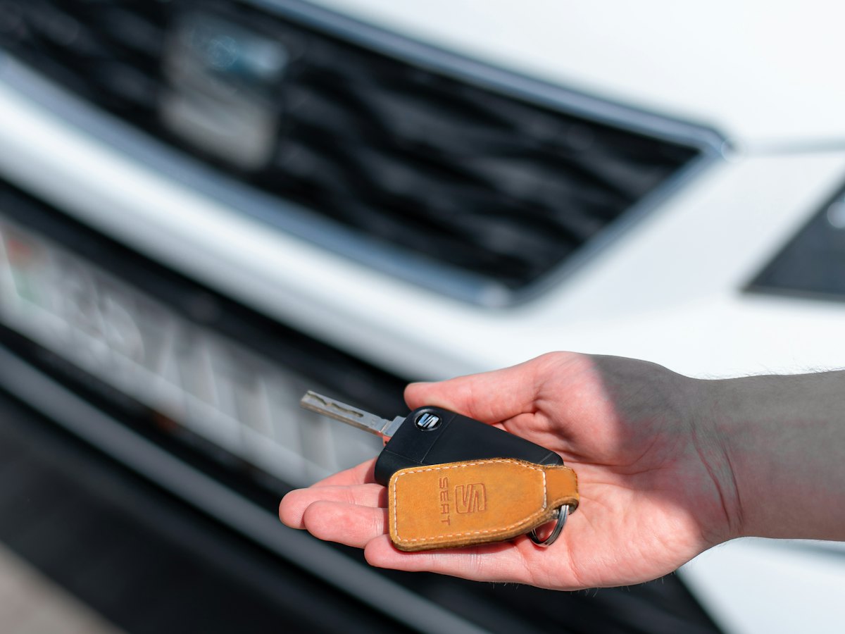 Hand holding out a car key