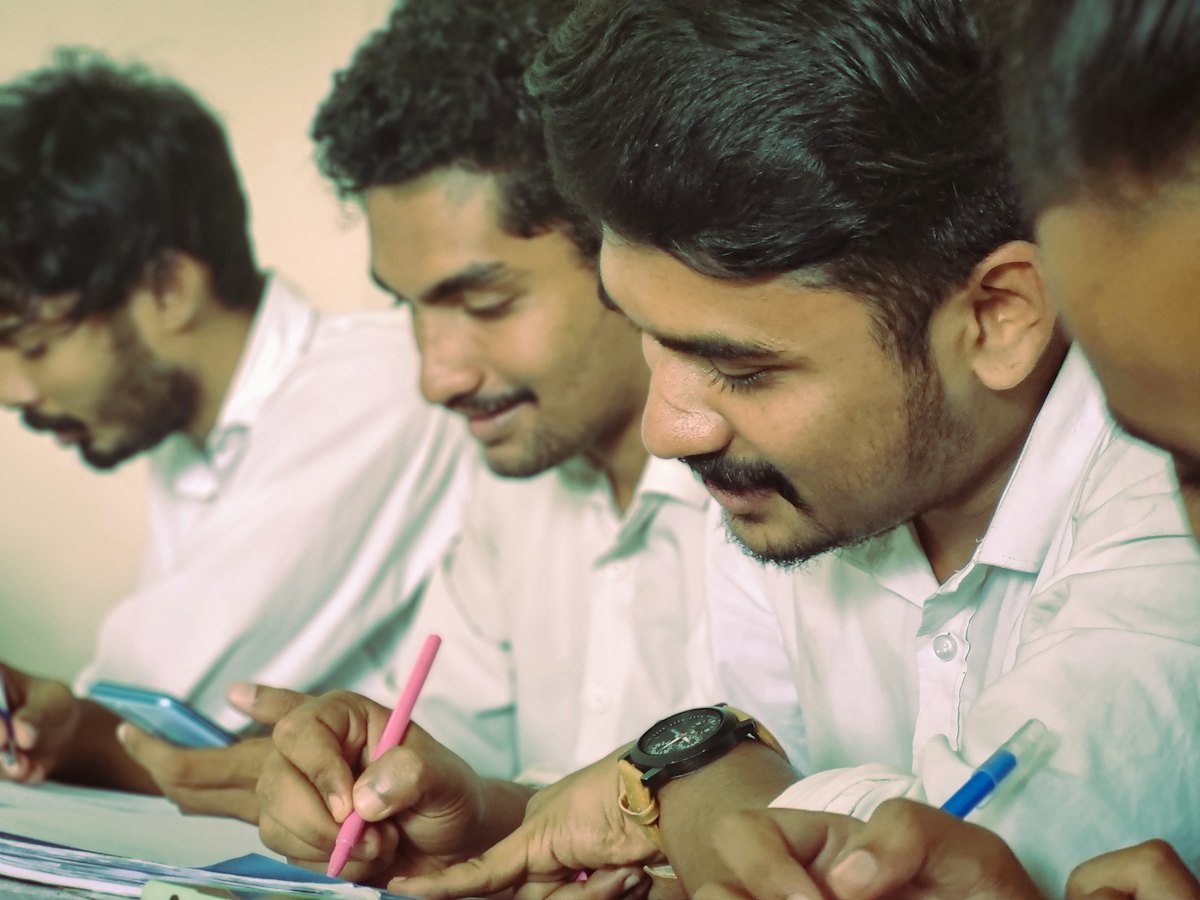 Indian students writing notes together