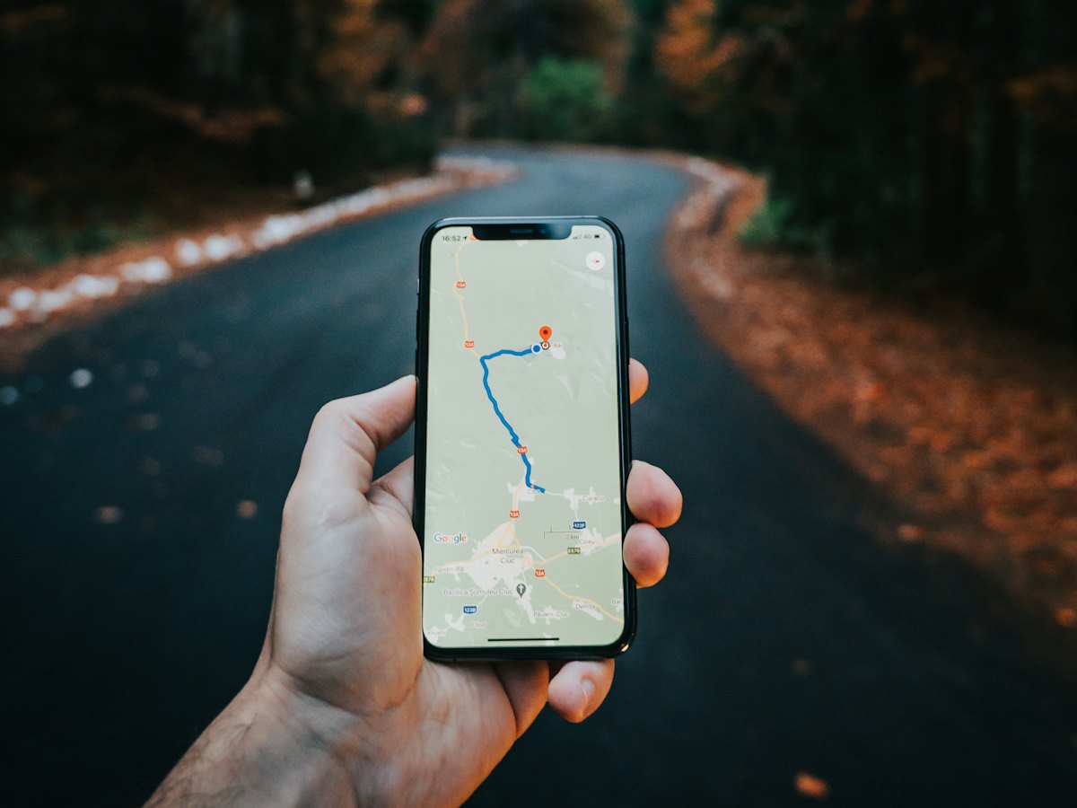 Hand holding a phone with map directions open