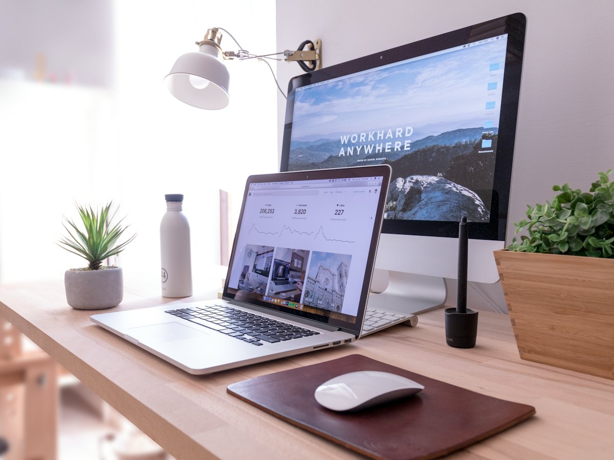 Laptop and desktop screen showing a website design
