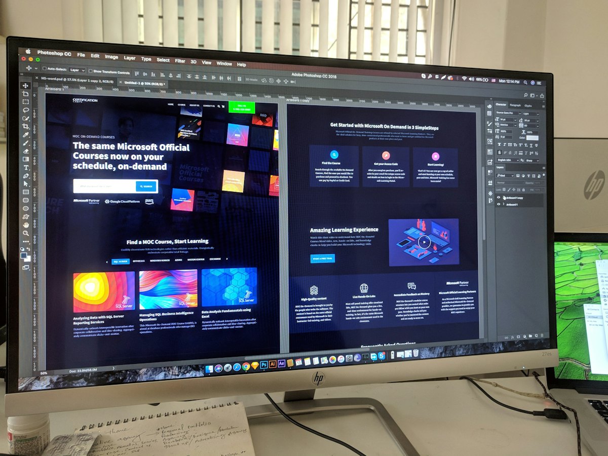 Designer working on web page layouts on a large screen