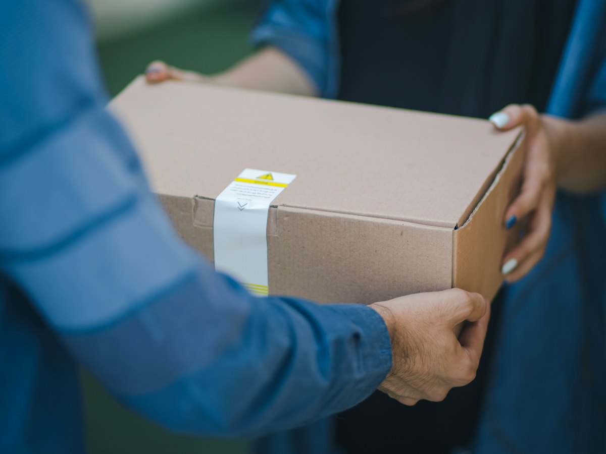 Person handing over a parcel