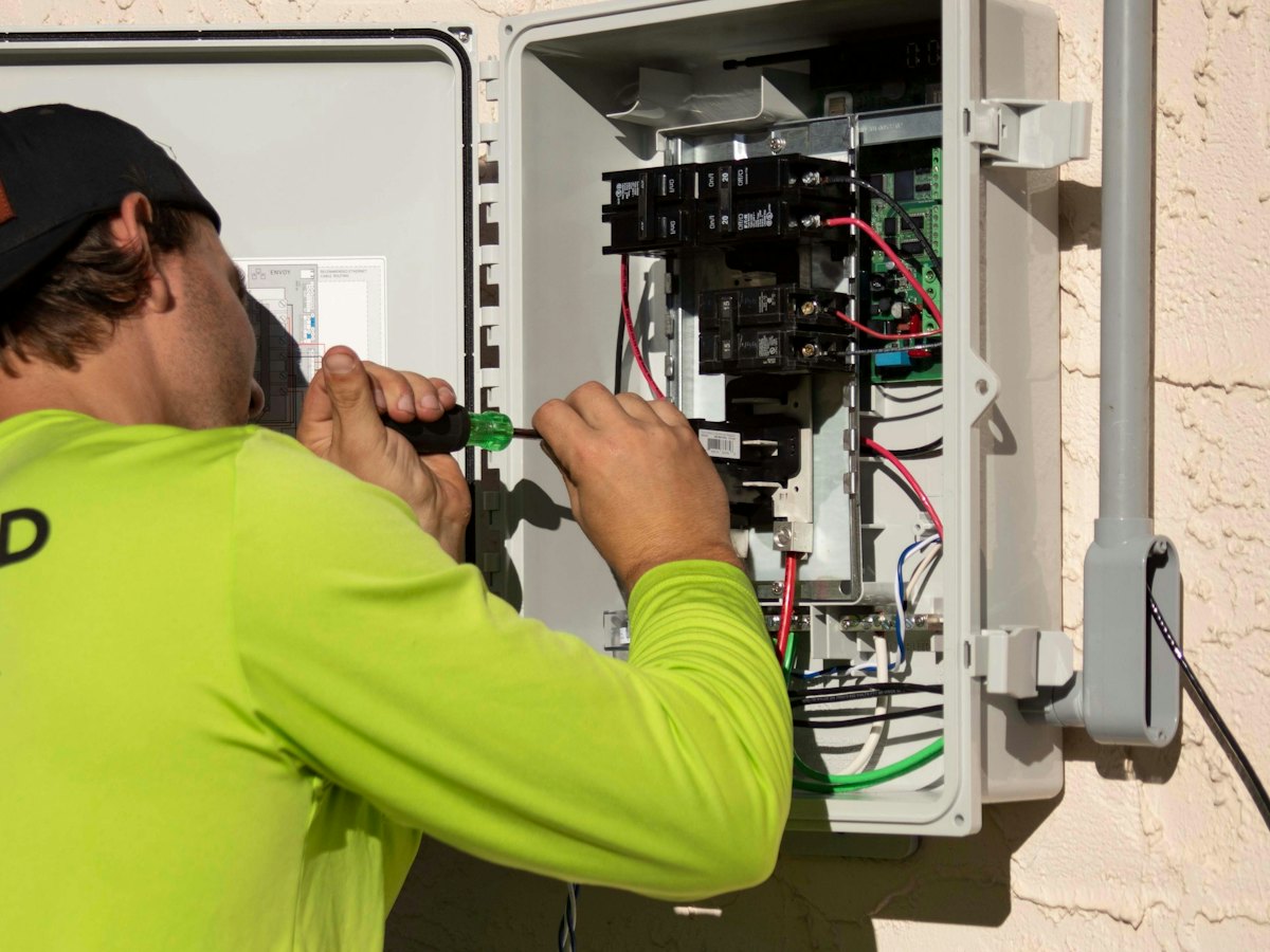 Technician working on an electrical panel