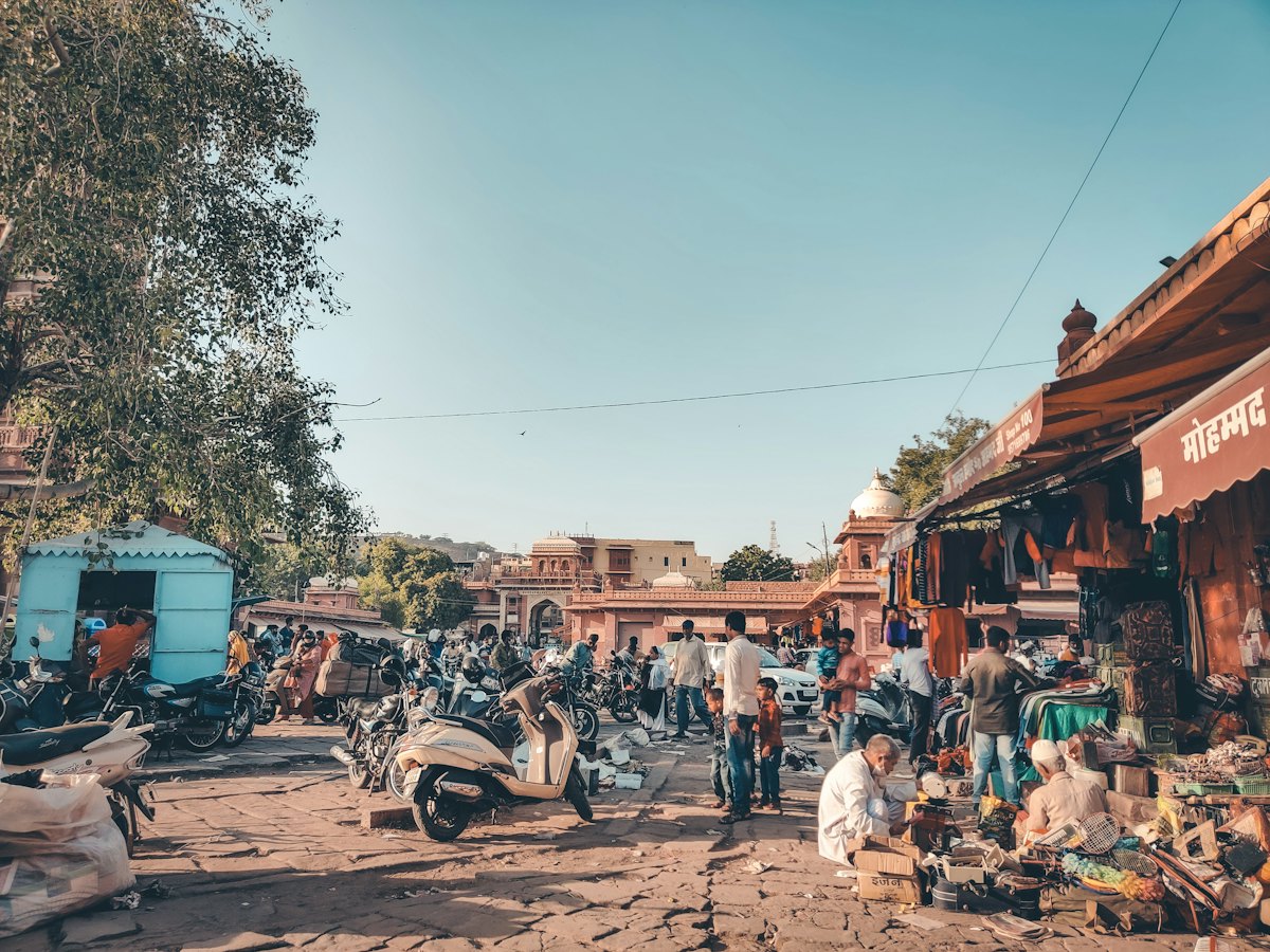 Town market street with parked scooters