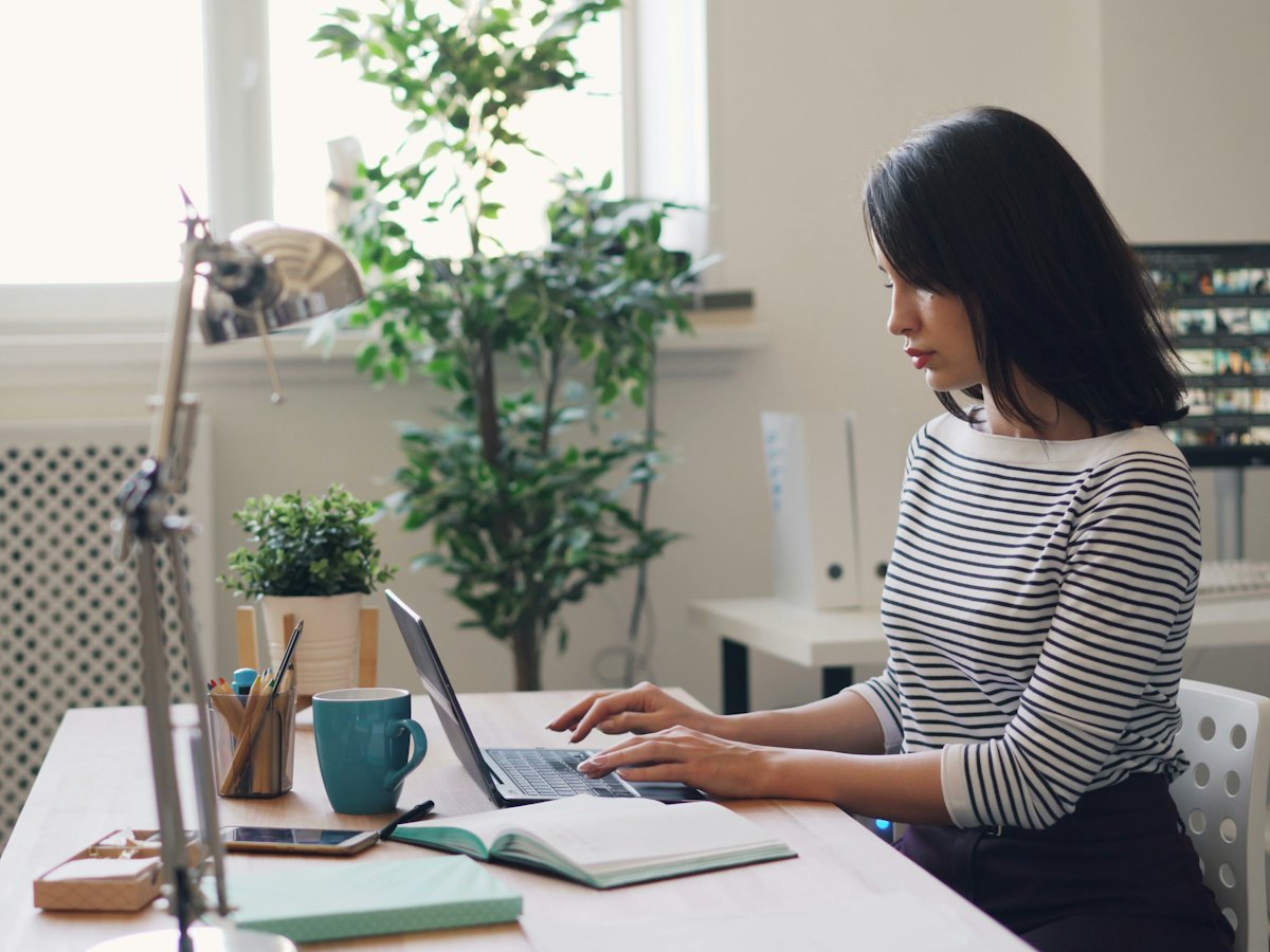 Woman working on a laptop in an office