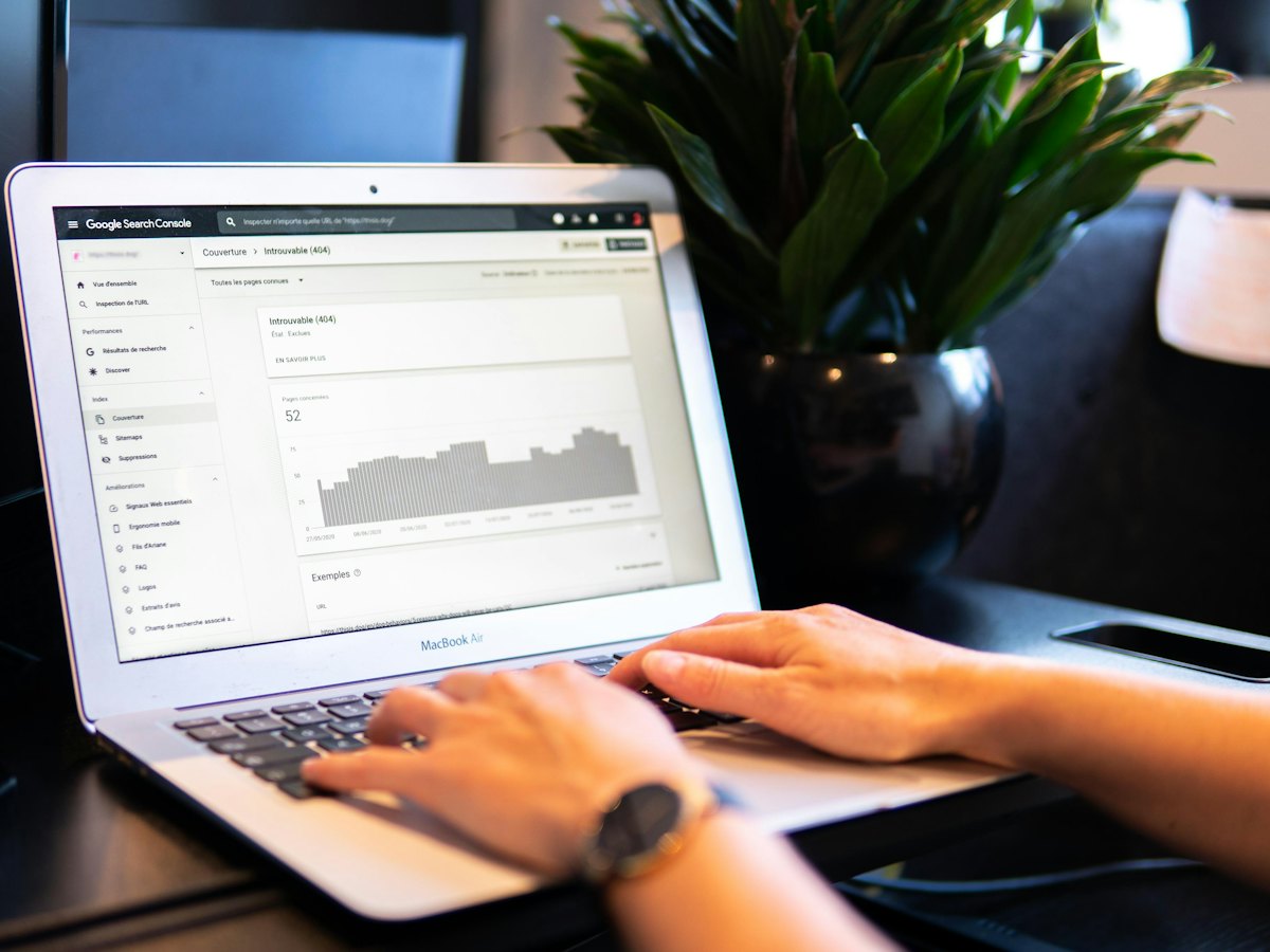 Person checking a search performance report on a laptop