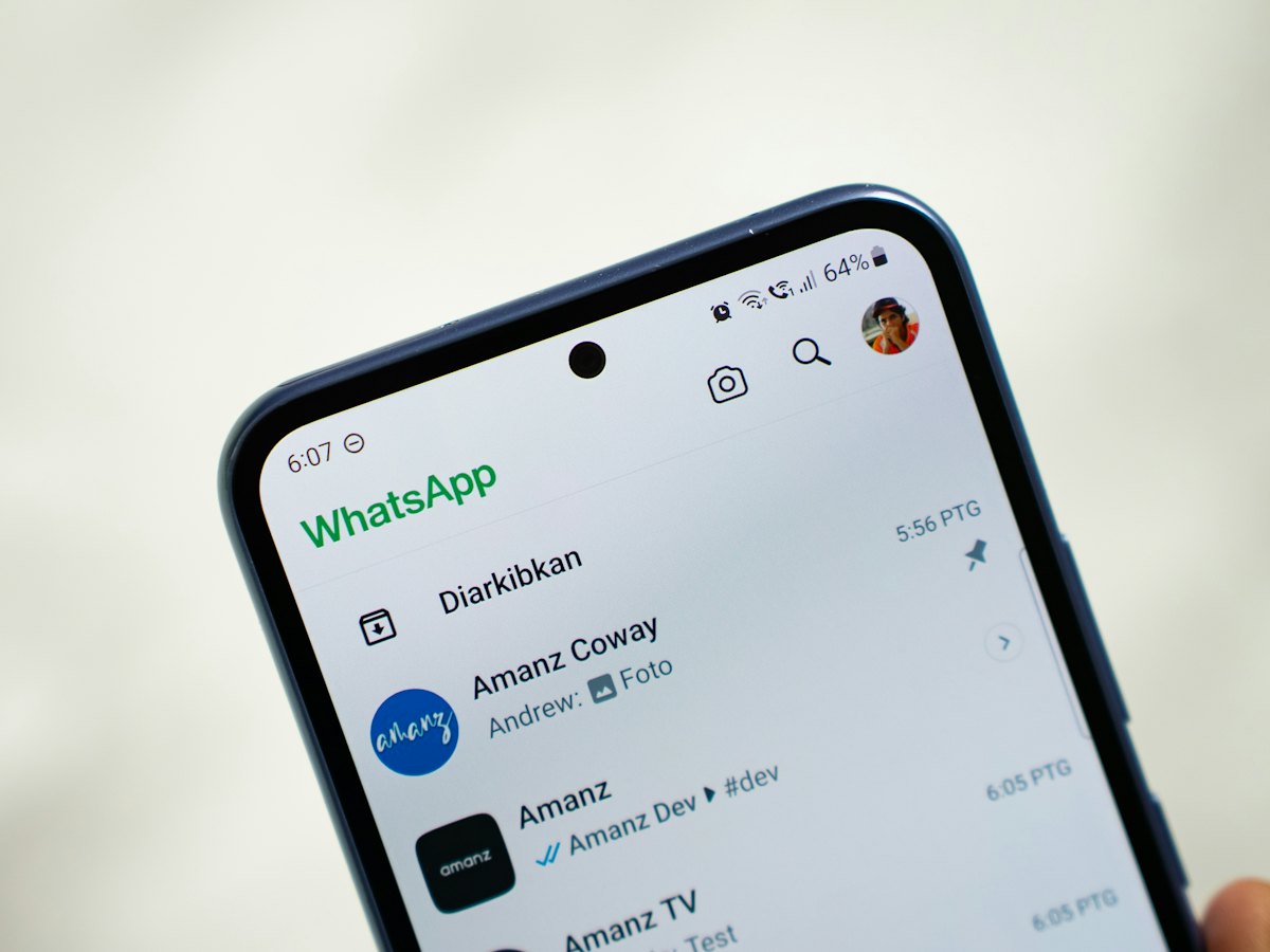 Phone showing a list of WhatsApp chats