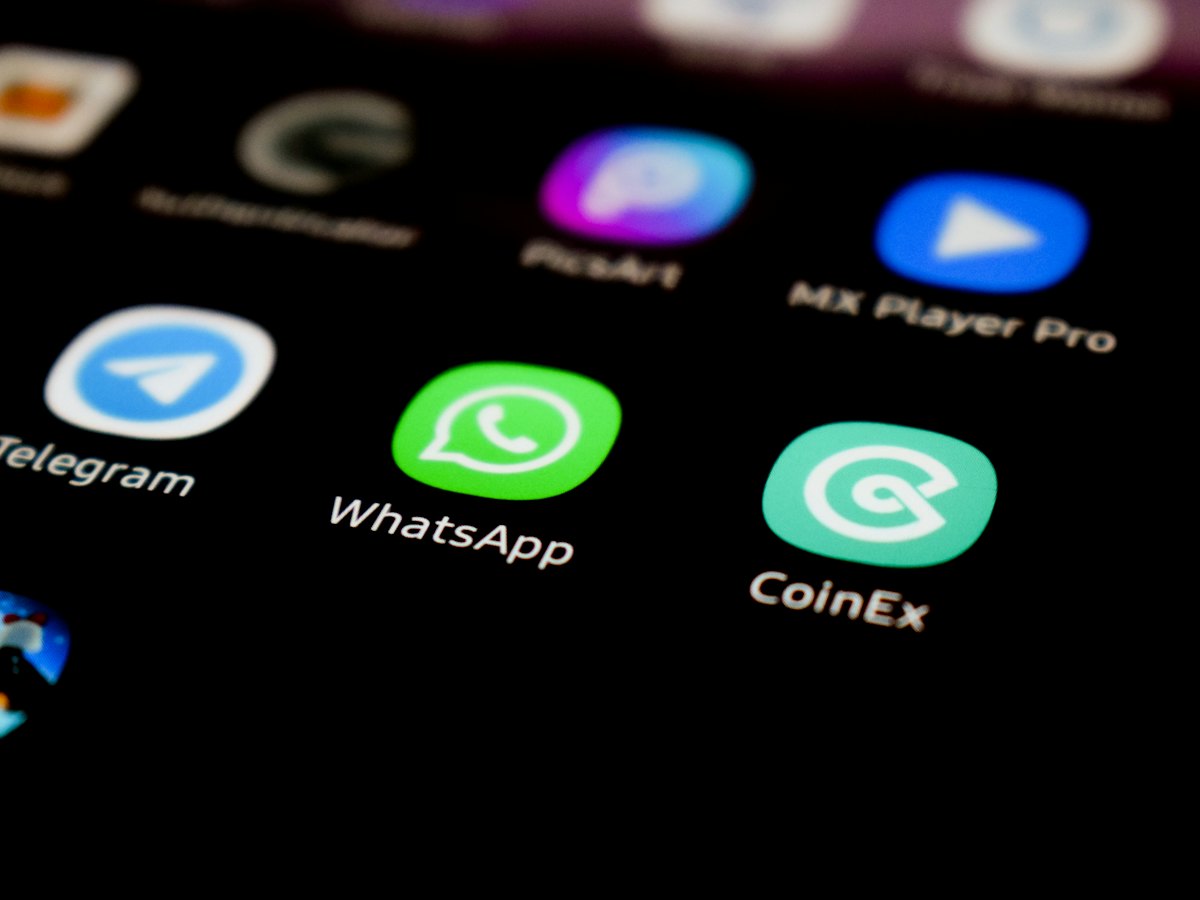WhatsApp and other messaging app icons on a phone screen